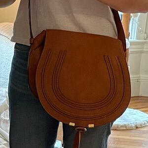 Tan Marcie medium saddle bag with adjustable straps for shoulder/crossbody use.